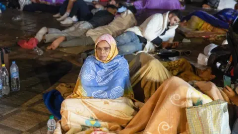 Getty Images A woman sitting outside in Marrakesh after an earthquake hit