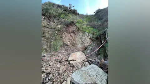 North Somerset Council Ladye Bay beach landslide showing fallen rocks in the foreground