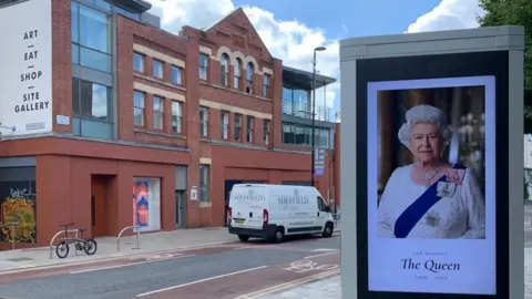 Image of the queen on a display board beside a road in Sheffield