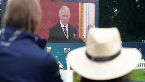 PA Media Spectators look on at Wentworth Golf Club in Virginia Water as the new King Charles III is formally proclaimed monarch