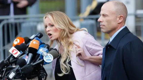 AFP Stormy Daniels, seen here with her lawyer Michael Avenatti, outside a federal court in Manhattan talking to reporters