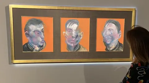 BBC An onlooker examines Three Studies for Self-Portrait by Francis Bacon