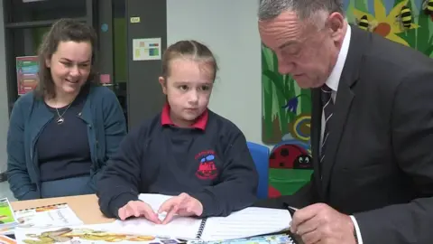 BBC Eryn demonstrates Braille reading to Maghaberry Prison governor David Kennedy