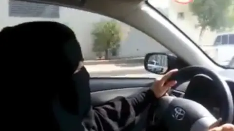 AFP A fully veiled woman driving in Riyadh ahead of a nationwide day of defiance of the female driving ban (17 October 2013)