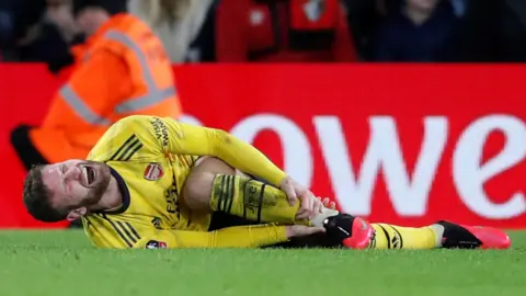 Mustafi screams in pain as he lies on the pitch holding his shin