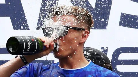 Getty Images James sprays champagne after an esports win