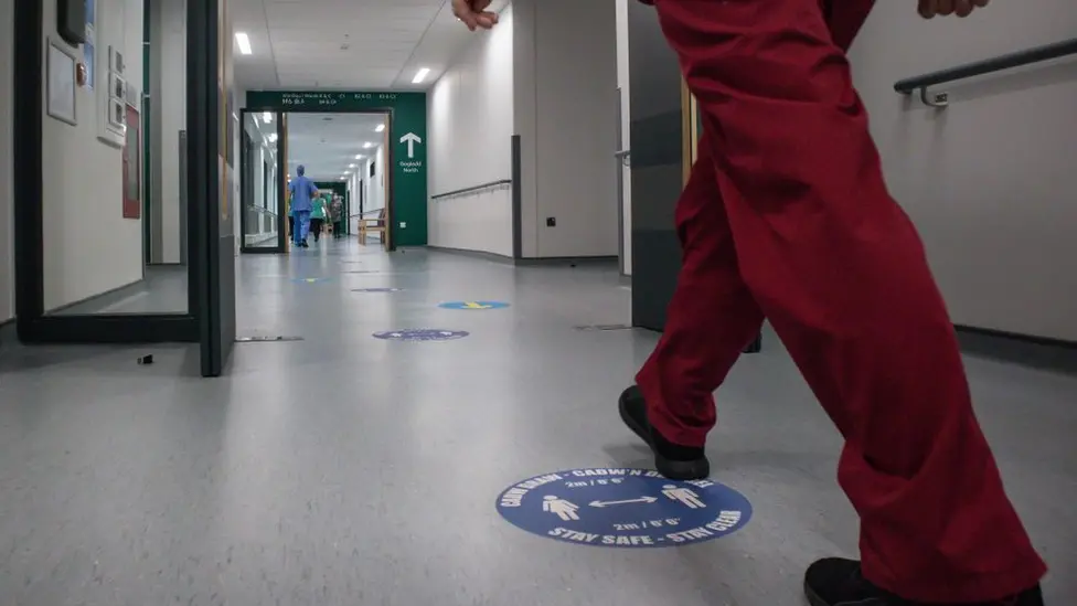 Getty Images Nurse walking in a hospital corridor