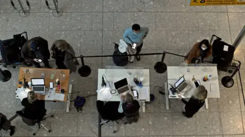 PA Media Passengers arrive at Heathrow Airport in London