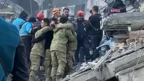 Rescuers hug after the survivor was found