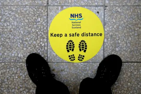 Getty Images physical distancing sign at Glasgow hospital