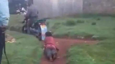 @DCI_Kenya Woman being dragged on a morotbike