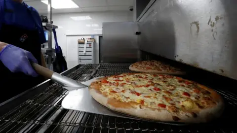 Reuters A domino's pizza being made