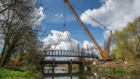 Leicester City Council New 11ft wide (3.5m) bridge was hoisted into place by a huge crane on Saturday