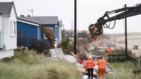 Joe Giddens/PA Workers oversee the demolition