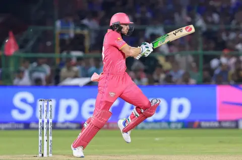 Getty Images Rajasthan Royals' Jos Buttler is playing a shot during the Indian Premier League (IPL) 2024 T20 cricket match between Rajasthan Royals and Royal Challengers Bengaluru at Sawai Mansingh Stadium in Jaipur, Rajasthan, India, on April 6, 2024.