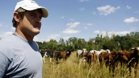 Getty Images Zimbabwean farmer Brian Bronkhoust on the farm which was seized by armed youths in Chegutu 120km south west of Harare (17 April 2009)