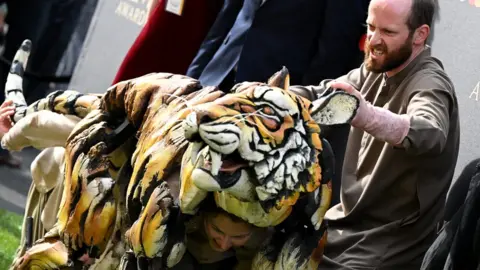 Getty Images The puppeteers from Life of Pi on the green carpet at the Olivier Awards