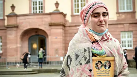 EPA Women protests outside the court where Anwar Raslan is on trial