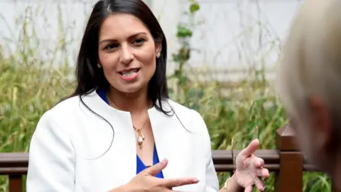 Reuters Britain's Home Secretary Priti Patel gestures as she speaks during a visit to the West Midlands Police Learning Development Centre in Birmingham