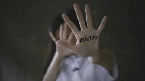 Getty Images A woman showing her hand with the MeToo slogan