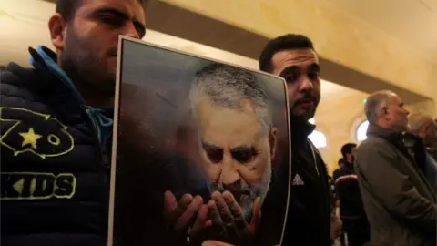 AFP Hezbollah supporters in Lebanon hold picture of Qasem Soleimani (03/01/20)