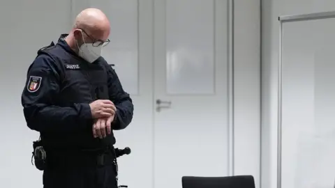 EPA A judicial officer in the court room in Itzehoe, Germany, 30 September 2021. A