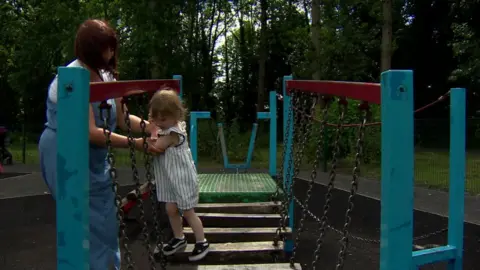 Justine Lewis with her daughter Willow playing