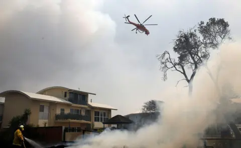 Reuters Helicopter drops water in Old Bar, NSW