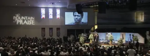 YouTube/NBC Mourners gathered at George Floyd's funeral, with an incorrect image on a big screen