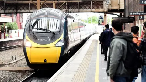 Getty Images People wait to get on the Avanti West Coast train at Stoke-on-Trent