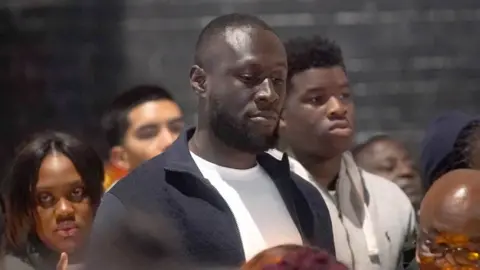 PA Media Stormzy attends the vigil