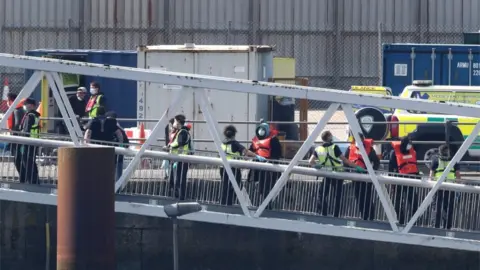 Gareth Fuller/PA Migrants arriving at Dover on Saturday