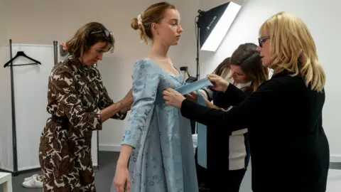 NETFLIX Phoebe Dynevor having her costume fitted