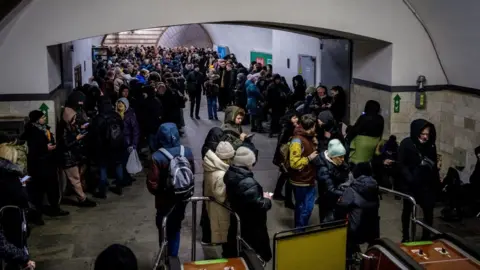 Getty Images A crowd of people take shelter in a Kyiv metro station