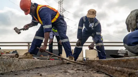BBC/Ayo Bello Workers doing repairs on the Third Mainland Bridge in Lagos, Nigeria