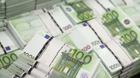 Reuters Bundles of 100 euro notes, 22 July 2013