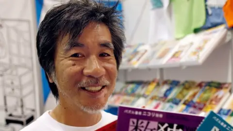 Reuters Maki Kaji holding Sudoku puzzle books in 2007