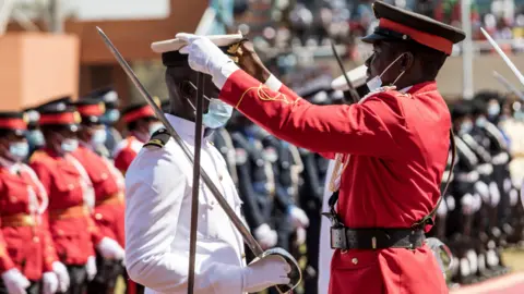 AFP A national guard gets his hat straightened in Banjul, The Gambia - Wednesday 19 January 2022