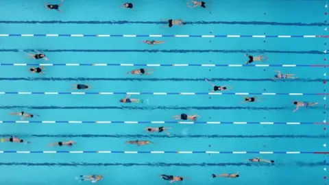 Reuters A drone photo of people swimming in lanes at a Lido