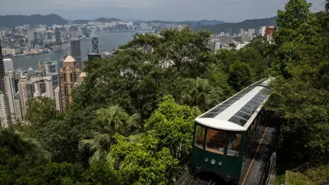 EPA A 6th generation Peak tram travels above Hong Kong