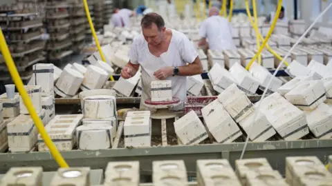 PA Media King Charles III themed mugs on display during the production of hand-decorated pieces from the forthcoming Coronation collection, at the Emma Bridgewater Pottery Factory in Stoke on Trent.
