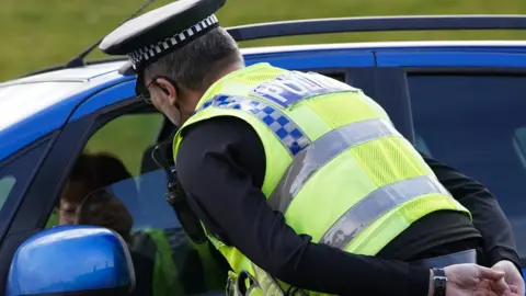 Getty Images Police officer making inquiries