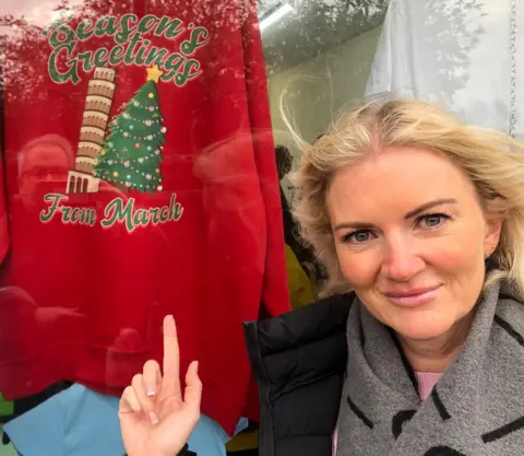 John Devine/BBC Shopper Claire Dean pictured with a wonky tree jumper