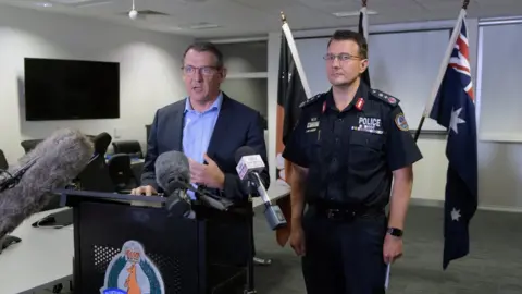 EPA Northern Territory Chief Minister Michael Gunner and Police Commissioner Reece Kershaw giving a press conference to journalists