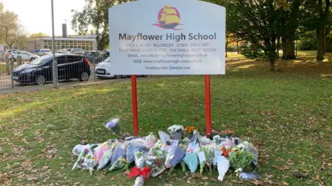 Lewis Adams/BBC Flowers left outside Mayflower High School