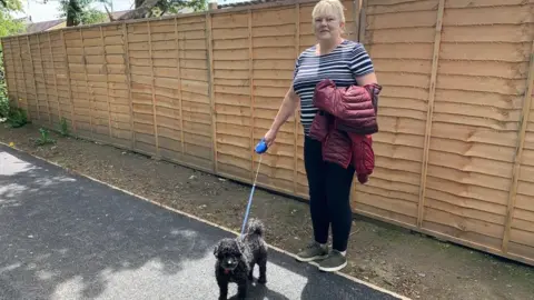 Tracy Mazzone with her dog on the footpath