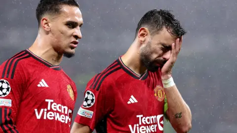 Manchester United players Antony and Bruno Fernandes look dejected after the loss to Galatasaray