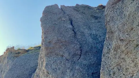 West Bay Coastguard Rescue Large crack in cliffs above Seatown Beach