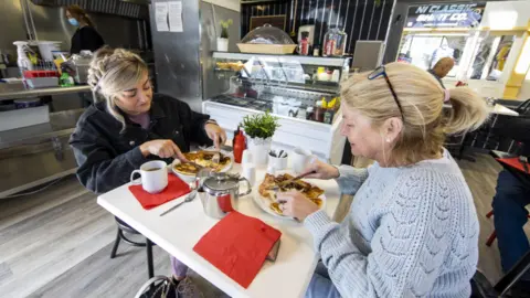 PA Media Two women share an Ulster fry