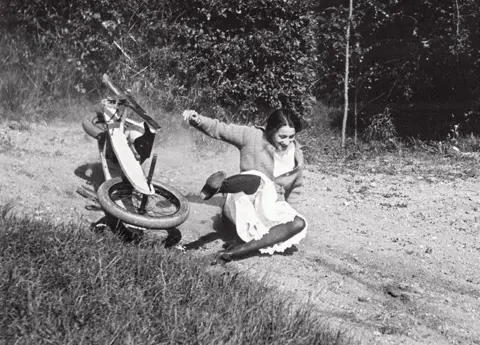 Jacques Henri Lartigue A woman falls off a go-kart whilst laughing